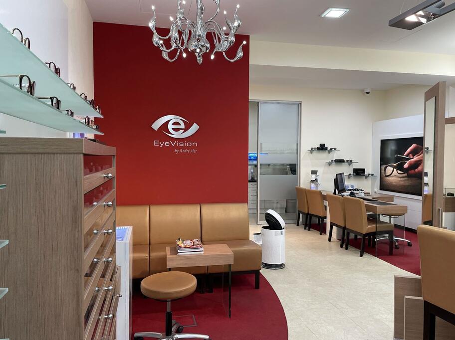 A store featuring a striking red wall adorned with an elegant chandelier, creating a vibrant and inviting atmosphere.