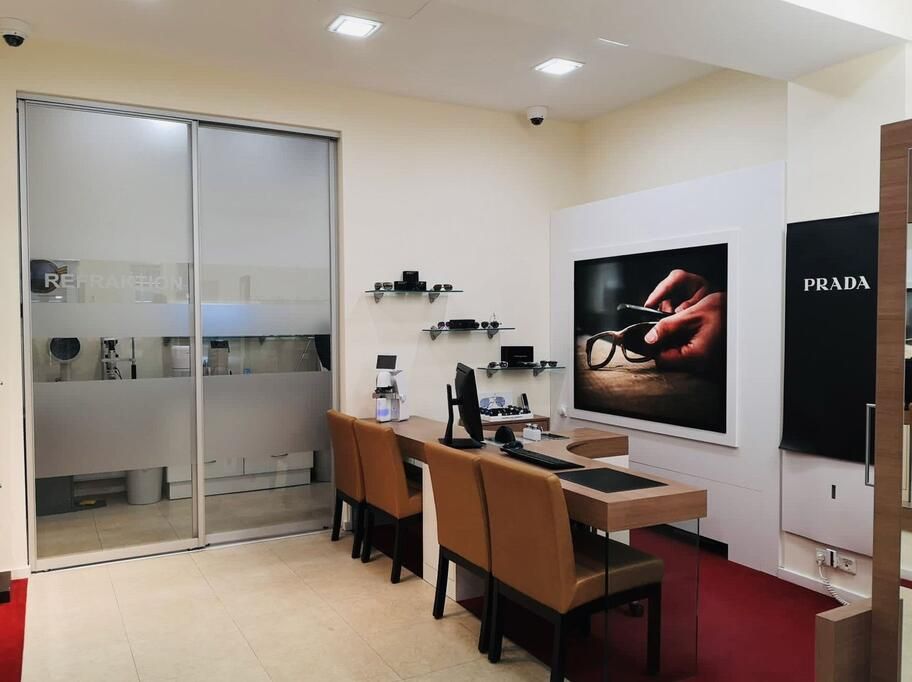 An interior view of a room showcasing a large mirror alongside a well-furnished table, enhancing the space's aesthetic.